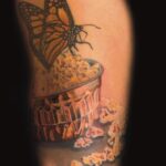 monarch butterfly on a bowl of popcorn tattoo by donavan moore