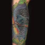 blue bird and rainbow scenic landscape tattoo by donavan moore