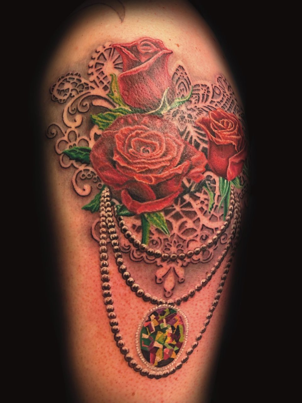 roses and pendant necklace surrealism tattoo by donavan moore