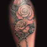 roses and beaded cross necklace tattoo by donavan moore