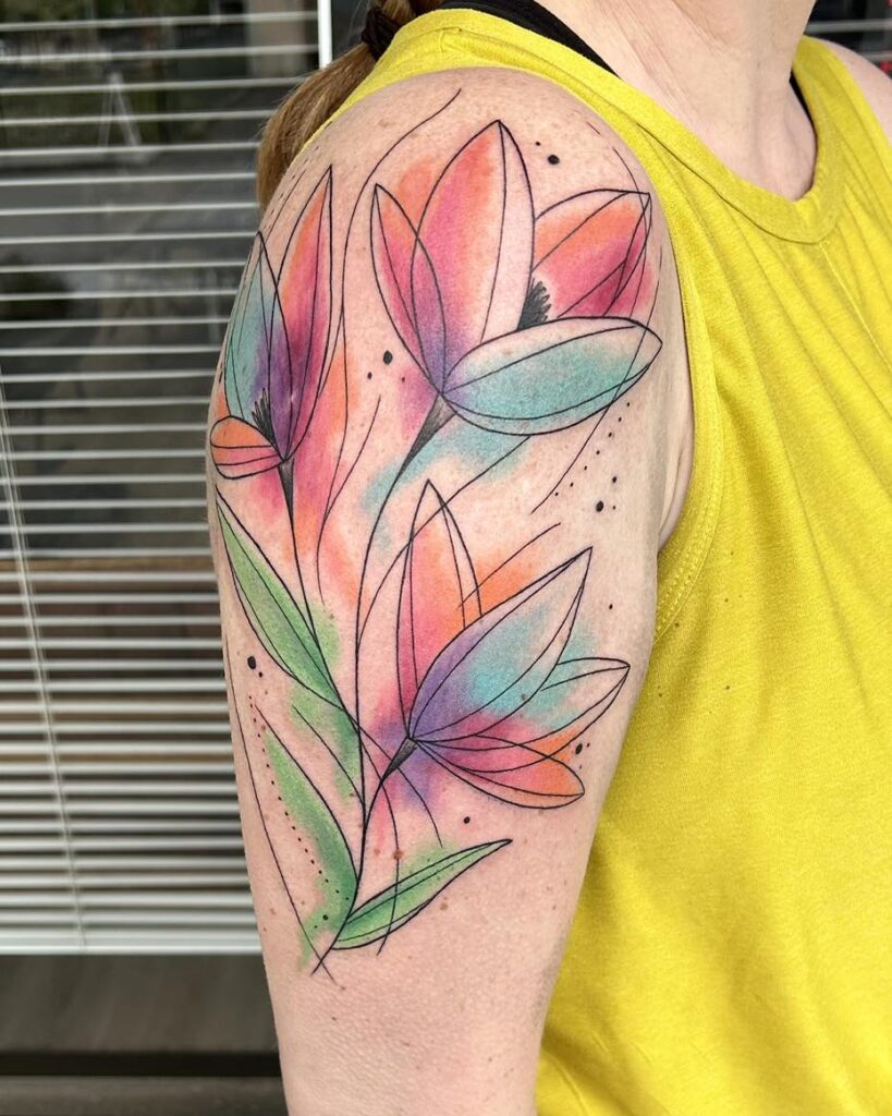Watercolor floral shoulder tattoo by Akira featuring abstract flowers with vibrant pink, orange, green, and purple ink and fine line detailing.